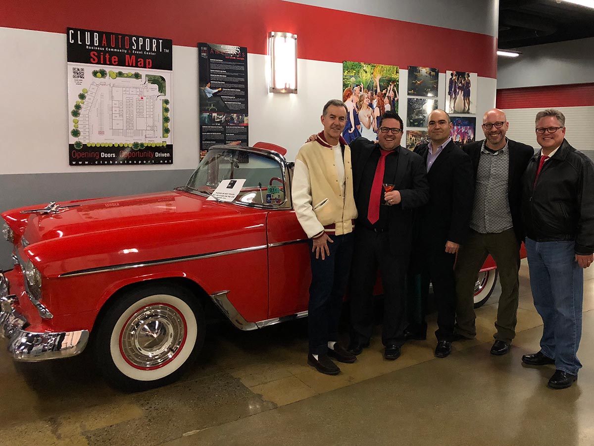 Organise legendary holiday party at local fancy car showroom.